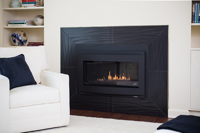 ELEMENTAL The old fireplace was replaced with a modern design flanked by built-ins. - Photography by Max Wedge (interiors) and Laura McCaffery (exterior)