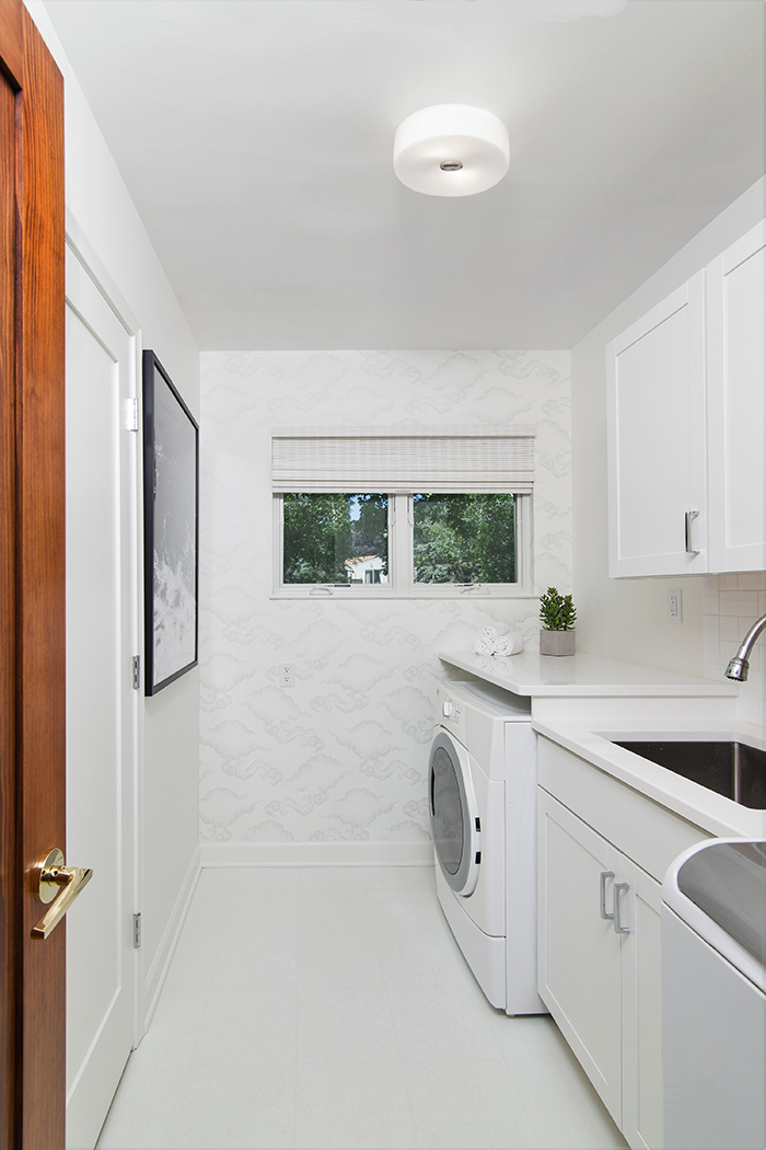 STYLE SPIN - There’s plenty of storage in the laundry room, where the designers worked around the homeowner’s existing washer and dryer.